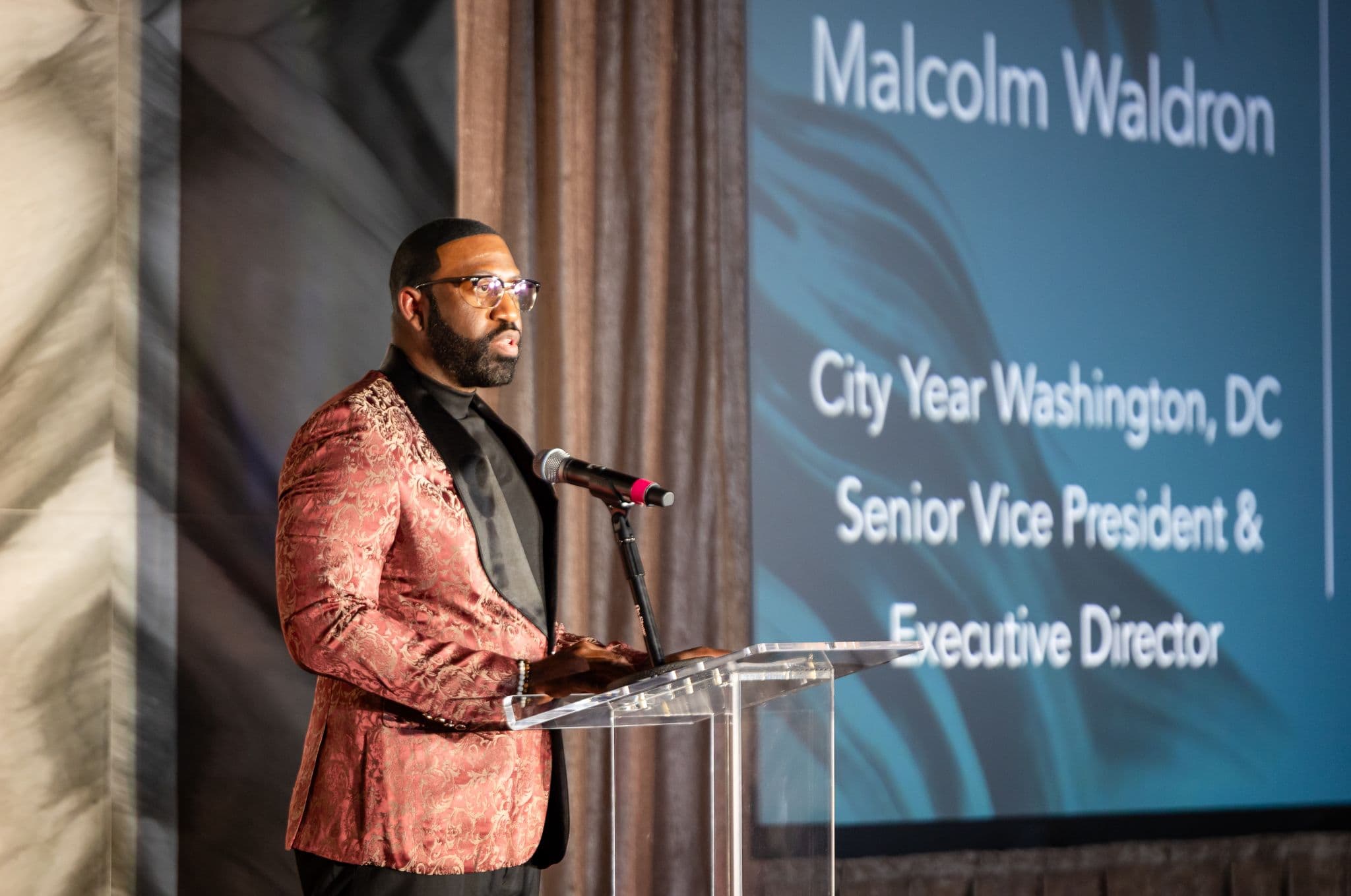 Selvon Waldron speaking at a podium